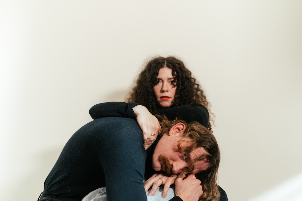 A promotional image for Honey Harper, Will Fussell with his hea din the lap of his wife, Alana Pagnutti.