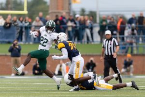 Sieh Bangura goes up against Kent State's defense while running the ball