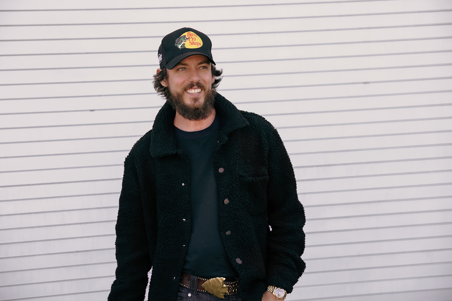 A picture of Chris Janson that is promotional - Chris is posing against a white wall.