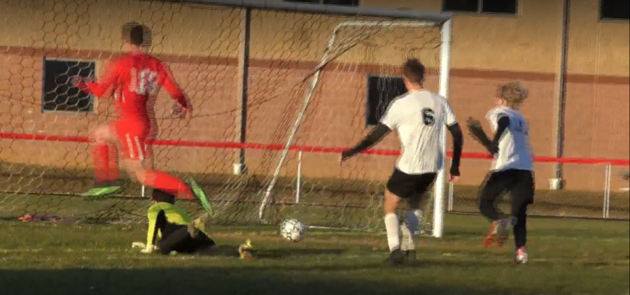 Shown: Senior Kyler D’Augustino (red) rounds the Miami Trace goalkeeper (neon) to secure his 100th career goal for Alexander Highschool.