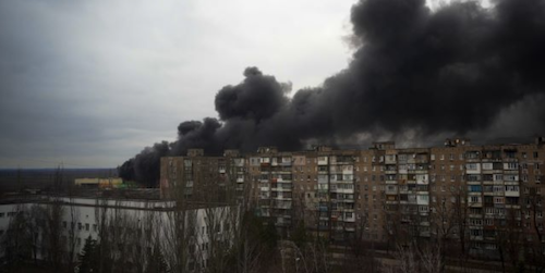 Ukrainian building with thick black smoke from the top after apparet bombing