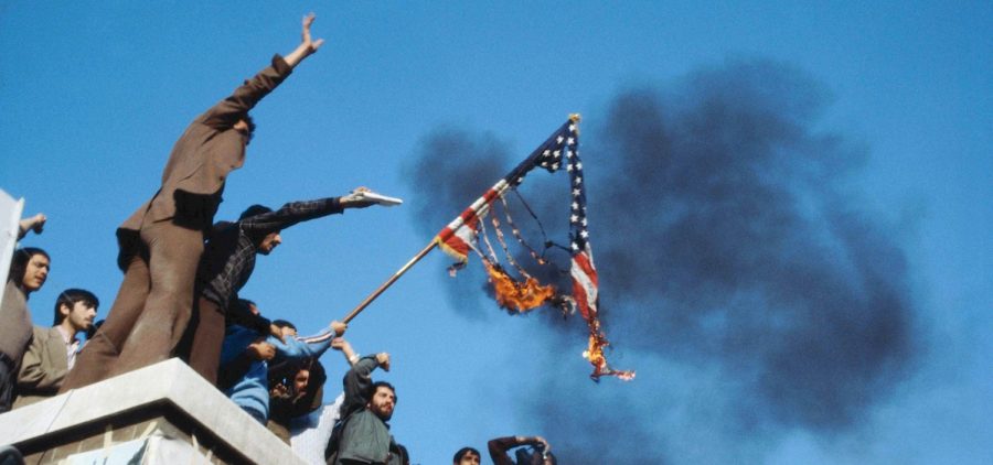 A group of hostage holders putting fire on the Amercian flag on the roof of the occupied U.S. embassy in 1980