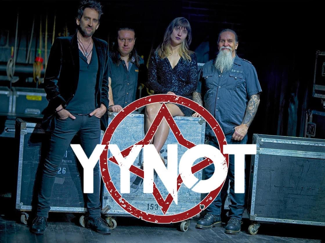 A promotional image for the band YNOT, a Rush tribute band. The band is standing in front of stage equipment.