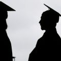 In silhouette, New graduates line up before the start of a community college commencement in East Rutherford, N.J., May 17, 2018.
