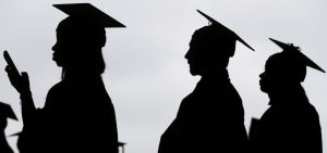 In silhouette, New graduates line up before the start of a community college commencement in East Rutherford, N.J., May 17, 2018.