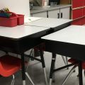 A few school desks pushed together.