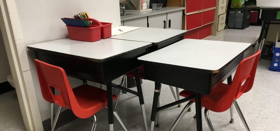 A few school desks pushed together.