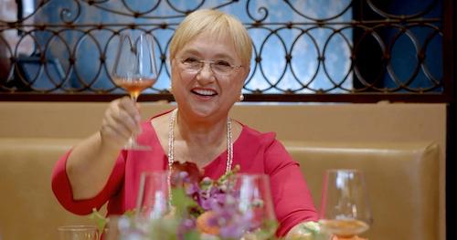 Chef Lidia raising wine glass to toast