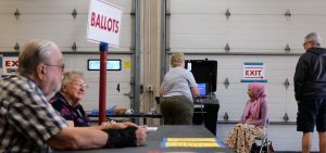 Poll workers and voters are seen during Wisconsin's state primary on Aug. 9.