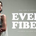 The promotional opening shot for the documentary "Every Fiber." The iage is of a model wearing a white outfit against a gray backdrop.