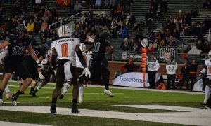 Ohio quarterback CJ Harris (10) leaps into the end zone against the Bowling Green Falcons 