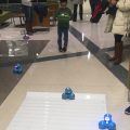 Children coding small robots with ipads