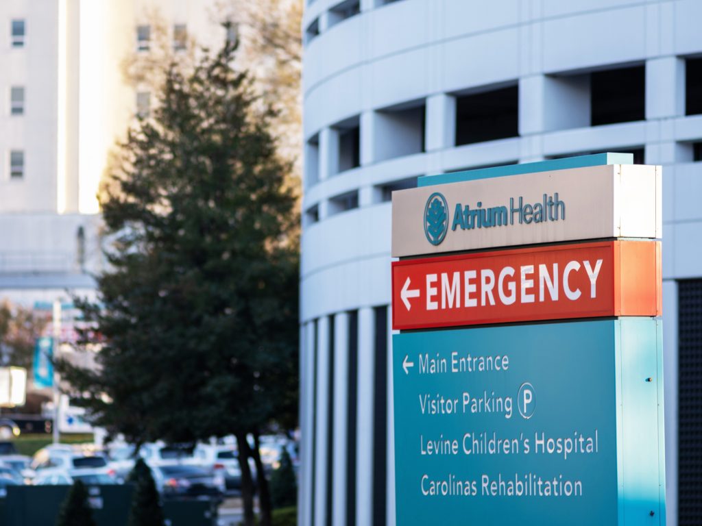 A sign outside of Atrium Health that points to the Emergency Department