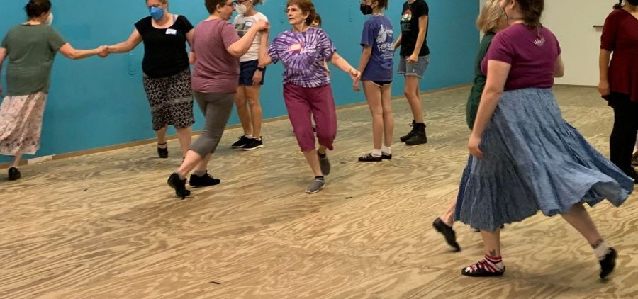 An image of people practicing dancing in a dance studio.