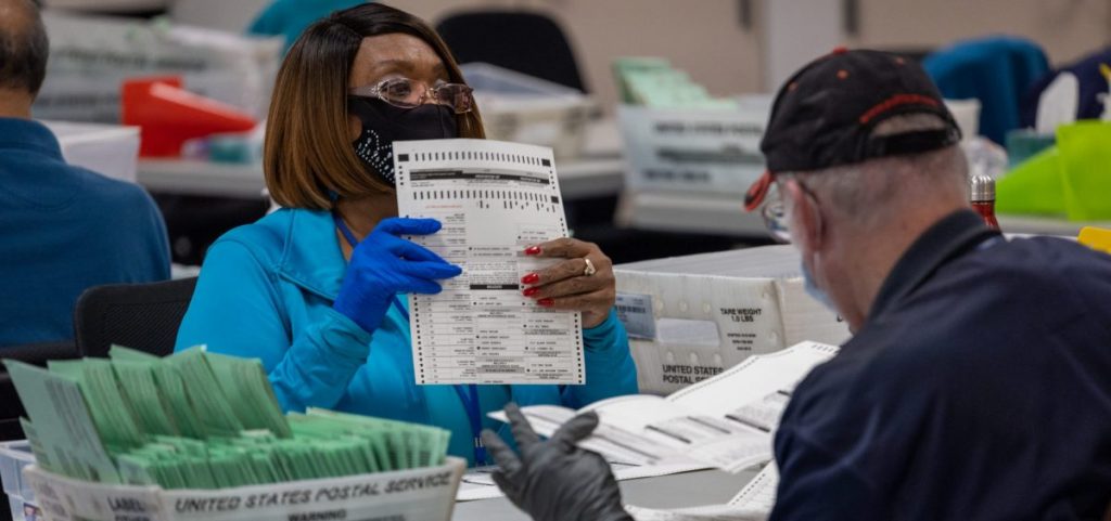 Election workers sort ballots at the Maricopa County Ballot Tabulation Center last week in Phoenix