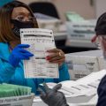 Election workers sort ballots at the Maricopa County Ballot Tabulation Center last week in Phoenix