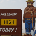 A Forest Service sign states that the fire danger is high