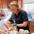 Cinde Lucas, whose husband Rick has suffered from long COVID, examines the many supplements and prescription medications he tried while looking for something to combat brain fog, depression and fatigue. that are on her kitchen counter.