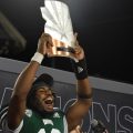 Quarterback CJ Harris holds up the Barstool Arizona Bowl MVP trophy which he earned in the Bobcats win against Wyoming