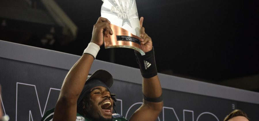 Quarterback CJ Harris holds up the Barstool Arizona Bowl MVP trophy which he earned in the Bobcats win against Wyoming