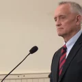 Joe Deters stands in front of a microphone