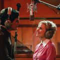 Michael Shannon and Jessica Chastain in a ‘George & Tammy’ duet recording scene. Music director, Rachael Moore, shared that all vocals were recorded live on set. This image shows Shannon and Chastain on set in a recording booth.