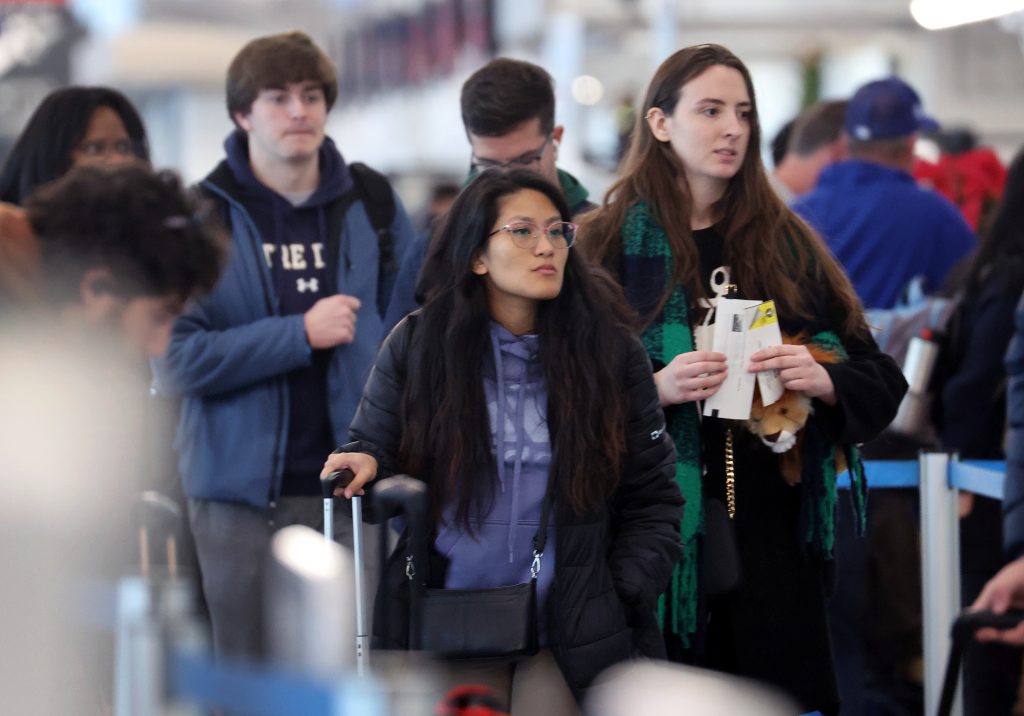 Travelers arrive for flights at the O'Hare International Airport, in Chicago