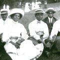 Photo portrait of African American family sitting on picnic grass in Sugarland, Maryland.