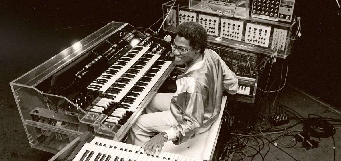 Don Lewis sitting at six keyboards with electronics