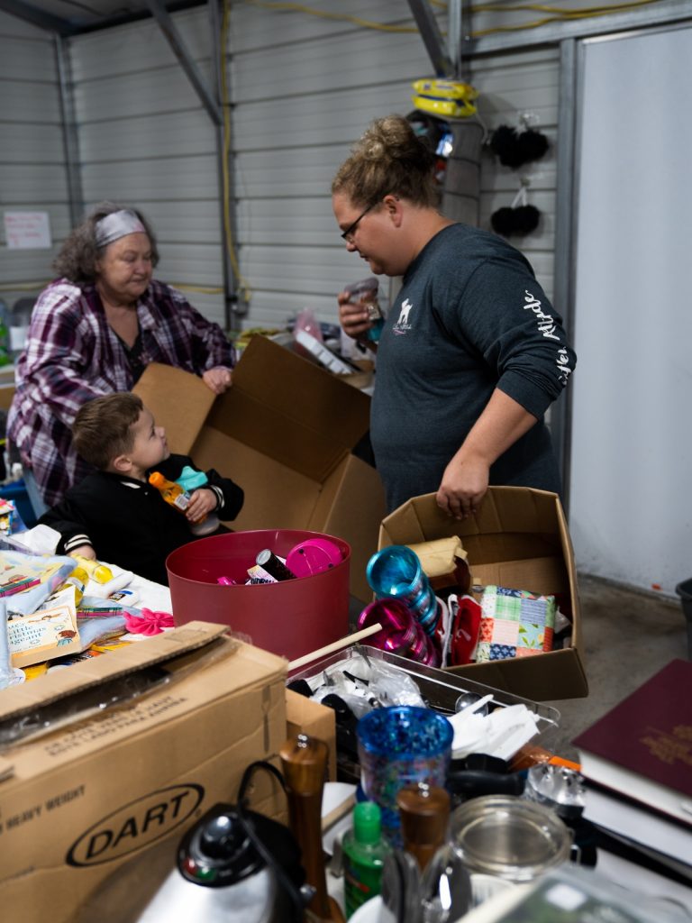 Riva Joseph and her son Corbin Joseph get items they need from a donation center ran by Jackie and Donna Roark in Litt Carr.