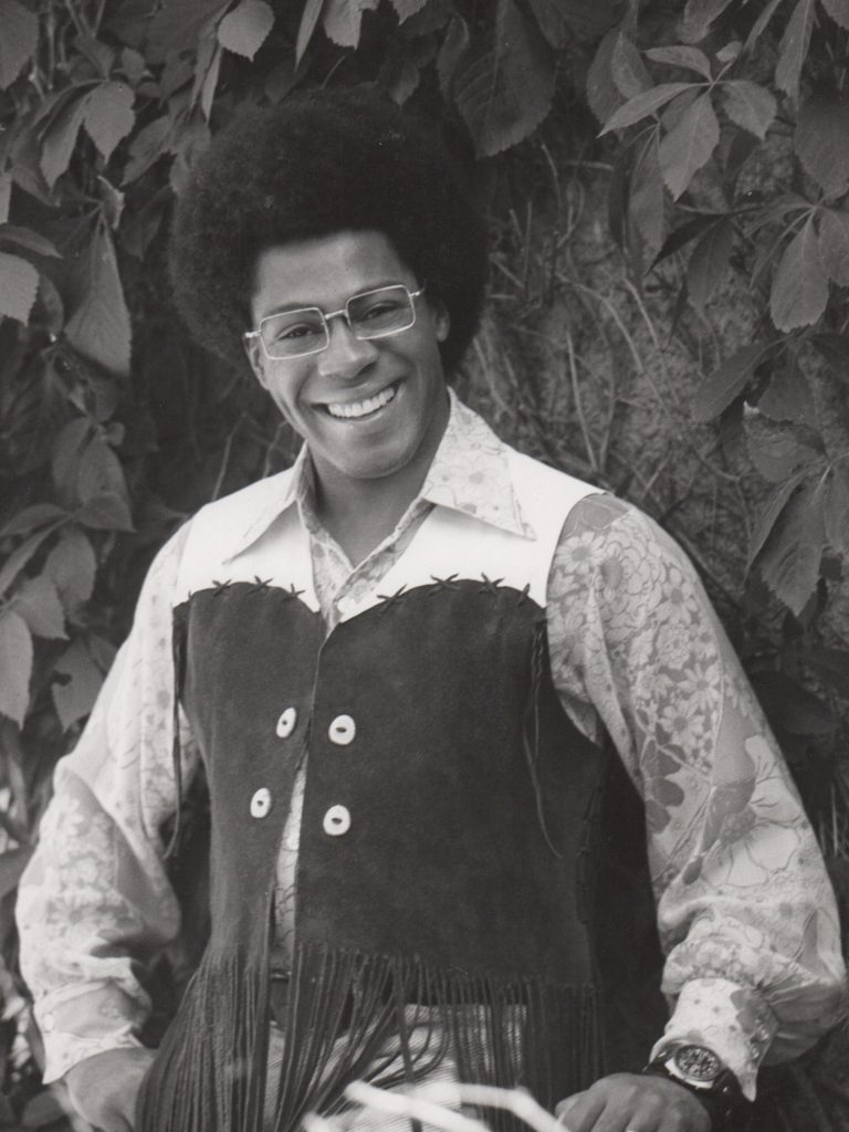 A black and white image of musician Don Lewis, wearing a fringed vest.