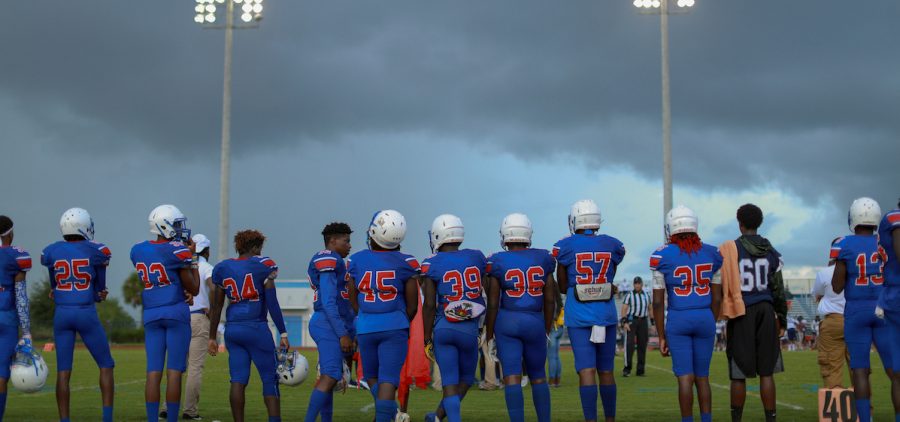Football Team lined up straight looking at field