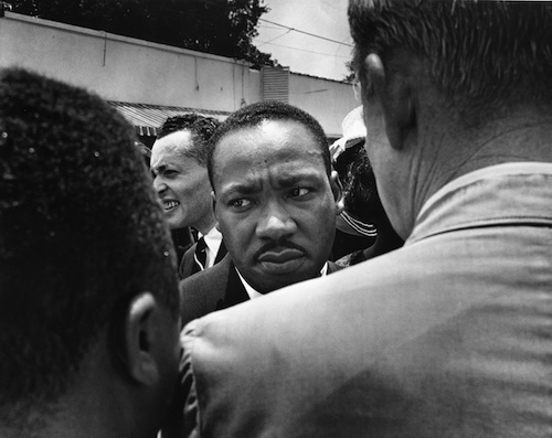 Martin Luther King, Jr. being confronted by Jackson, Miss. police during the funeral march for slain Miss. NAACP leader Medgar Evers, June 1963