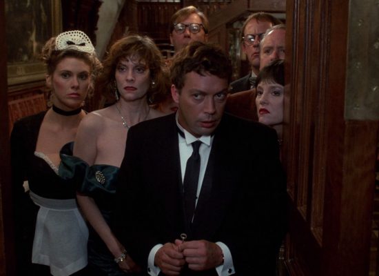 A still from the film "Clue" with the actors in the film all looking questioningly.