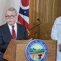 Gov. Mike DeWine and his Ohio Department of Health director Dr. Bruce Vanderhoff announce that DeWine has vetoed a ban on local bans of flavored tobacco products at a podium with the seal of Ohio on the front
