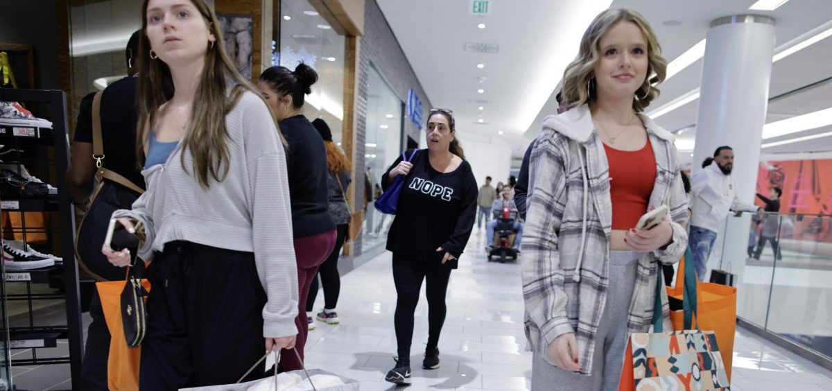 Women carry shopping bags as customers visit the American Mall dream mall during Black Friday