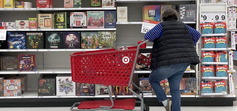 A Target shopper looks at a bunch of board games.
