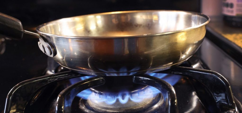 A skillet on a gas stove.