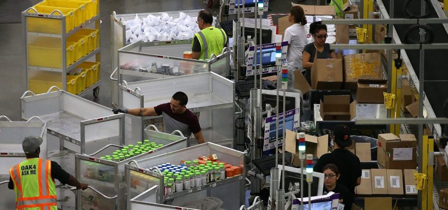 Workers pack orders at an Amazon fulfillment center on January 20, 2015 in Tracy, California.
