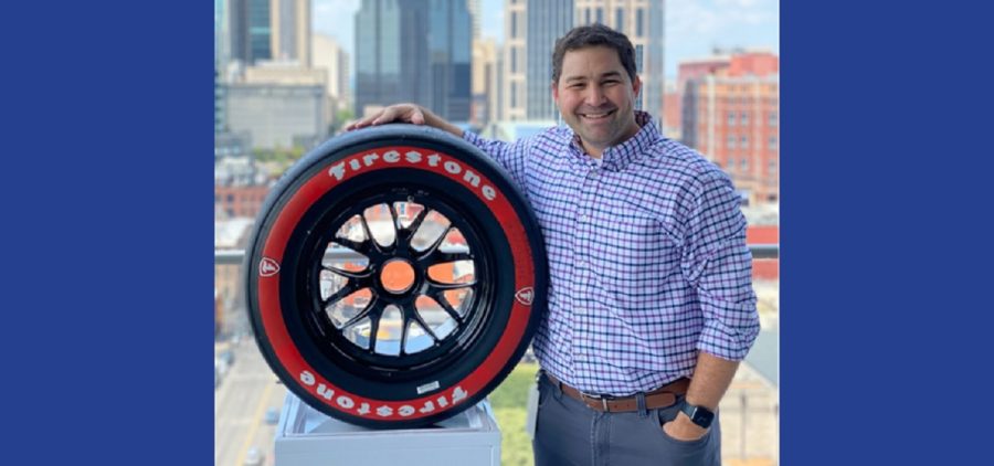 Keith Cawley posing with Firestone tire