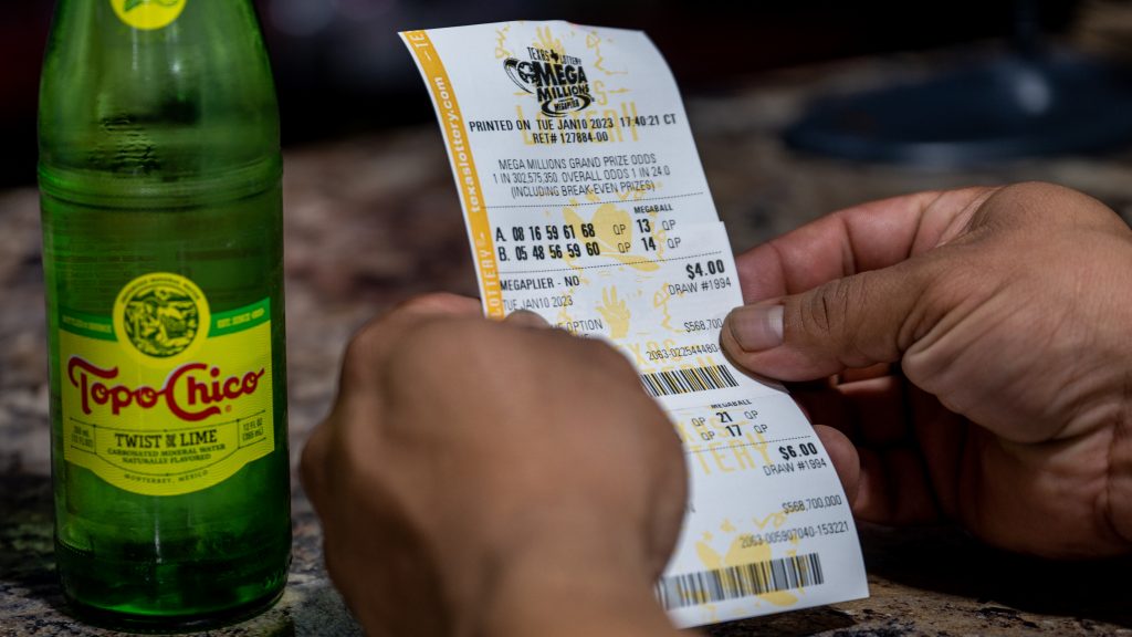 A customer looks at his lottery ticket at a CITGO gas station in Austin, Texas, on Jan. 10, as the Mega Millions jackpot climbed further above the $1 billion mark.