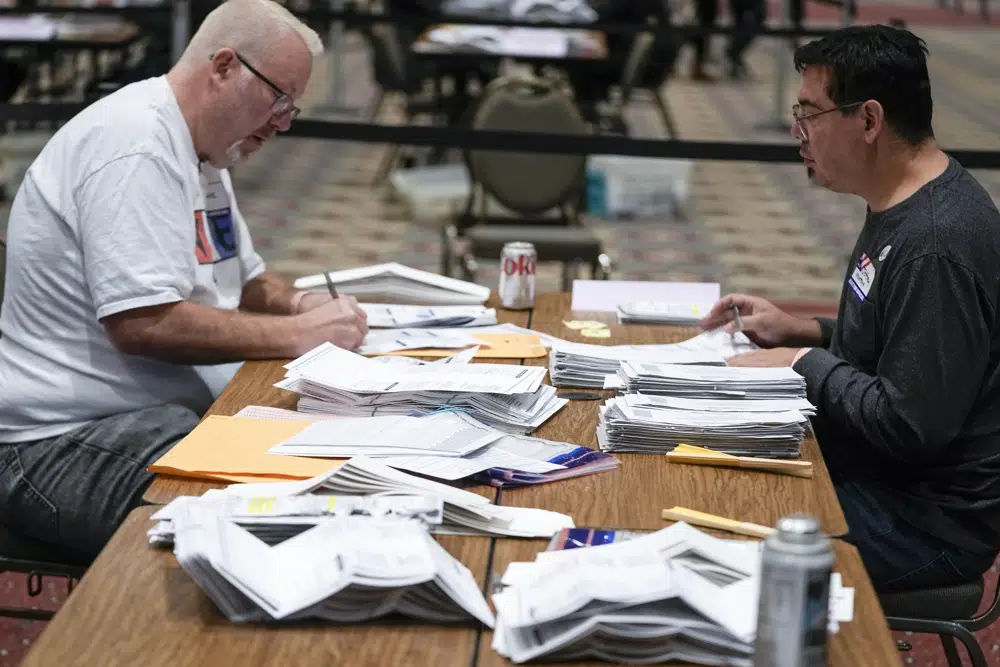 A worker counts ballots on a table in Milwaukee.