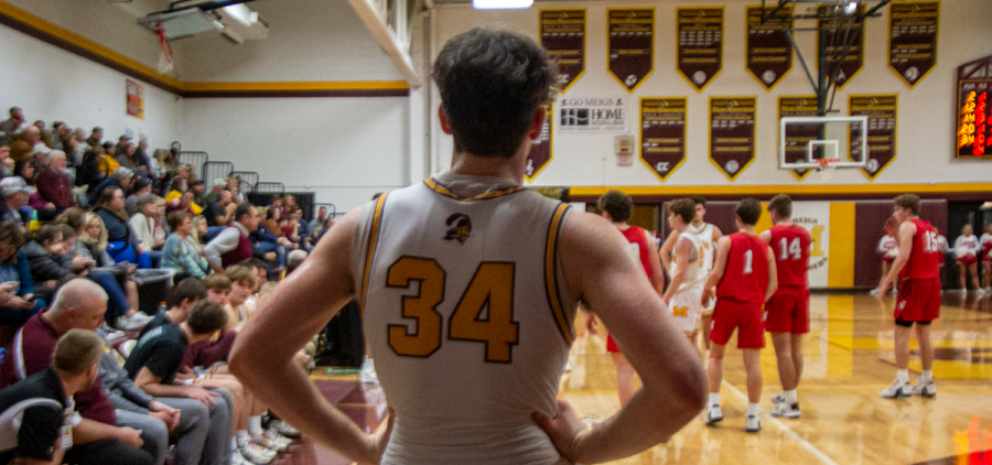 Meigs sophomore Dustin Vance looks at the court during a break in a game against the Jackson Ironmen