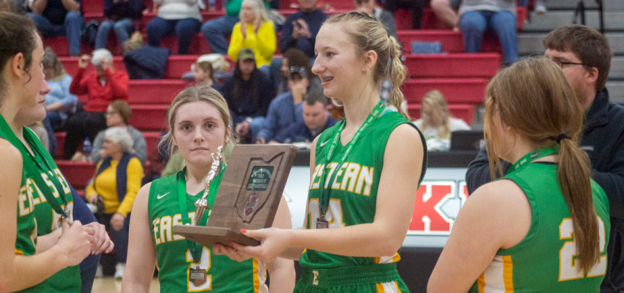 The Eastern Lady Eagles Sydney Reynolds holds the district Runner up trophy after the loss to Notre Dame