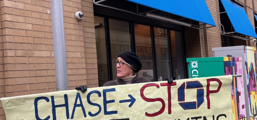 An image of a protesting sign outside of a Chase bank location.