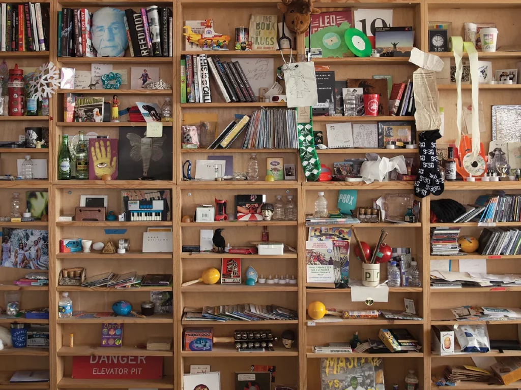 The bric-a-brac-stacked shelves of the Tiny Desk. 