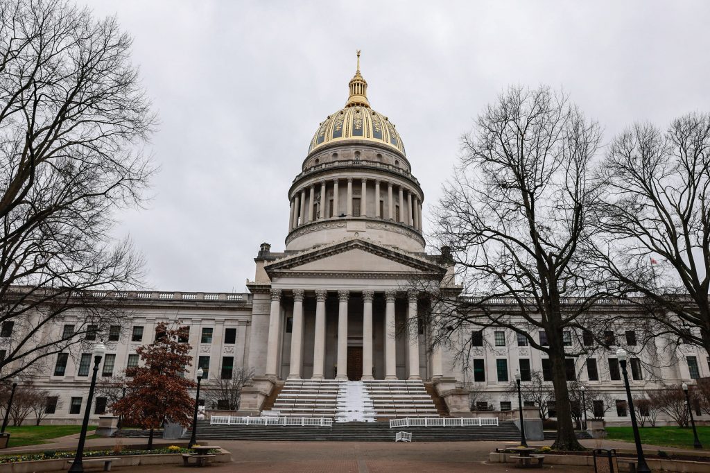 A view of the West Virginia Statehouse before Gov. Jim Justice's second inauguration in 2021. It's an overcast day and the picture is tilted up toward the gold dome on top of the building