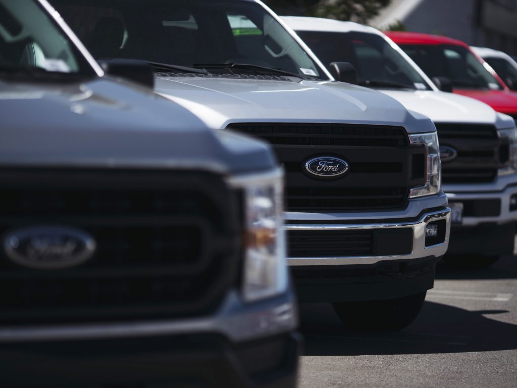 The blue Ford emblem is seen on a new trucks at a dealership on September 23, 2022 in Long Beach, California
