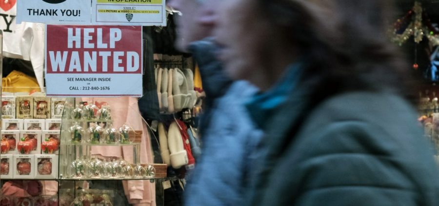 A 'help wanted' sign is displayed in a window of a store in Manhattan on December 02, 2022 in New York City.