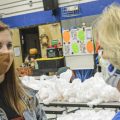 Reporter Amelia Knisely interviews a person at a food bank.